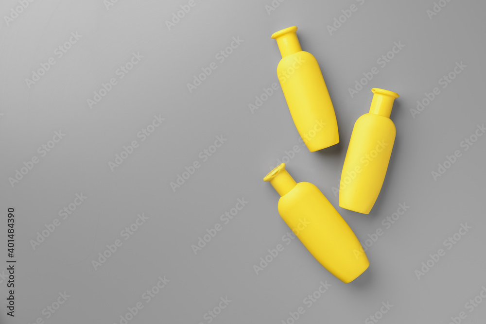 Yellow cosmetic container on gray background top view Yellow cosmetic container on gray background top view