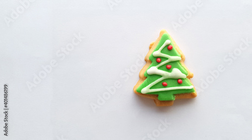 Christmas tree decoration on butter cookies on white background