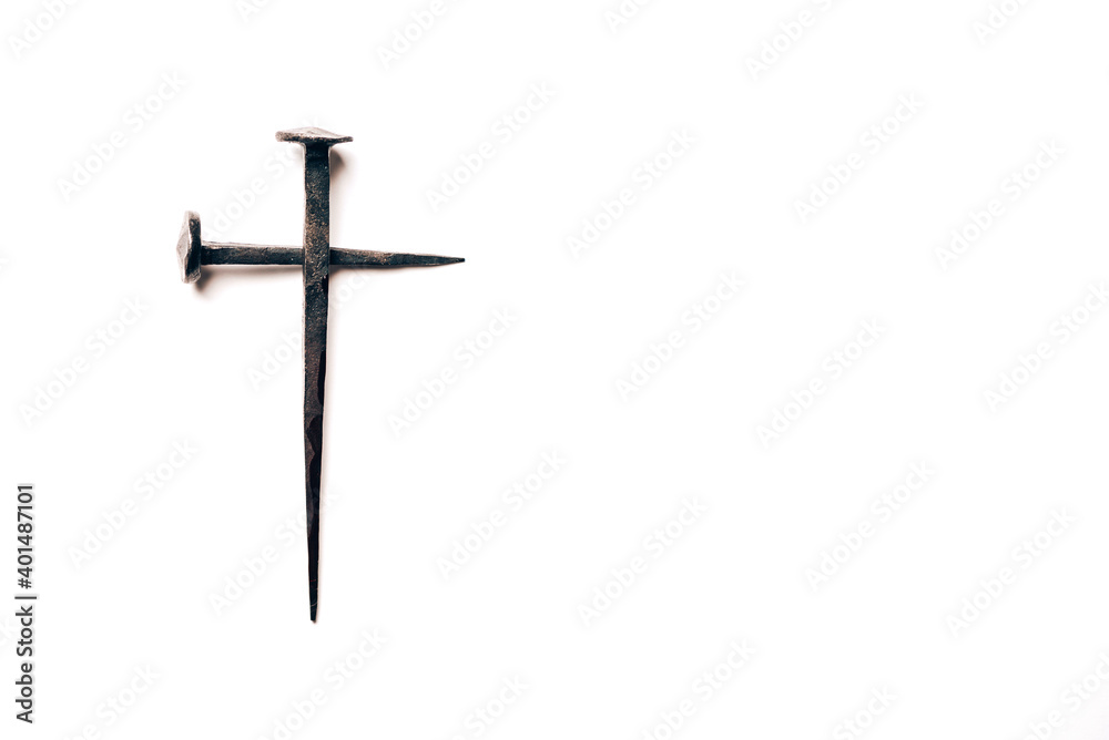 Cross made with rusty nails and drops of blood on white background. Copy space. Good Friday, Easter day. Christian backdrop. Biblical faith, gospel, salvation concept. Crucifixion of Jesus Christ