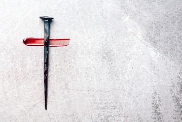 Christian cross made with rusty nails, drops of blood on grey background. Copy space. Good Friday, Easter day. Christian backdrop. Biblical faith, gospel, salvation concept. Jesus Christ Crucifixion