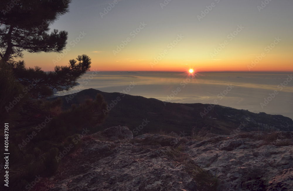 Sunrise with rays of light over the sea from the height of mount AI-Petri