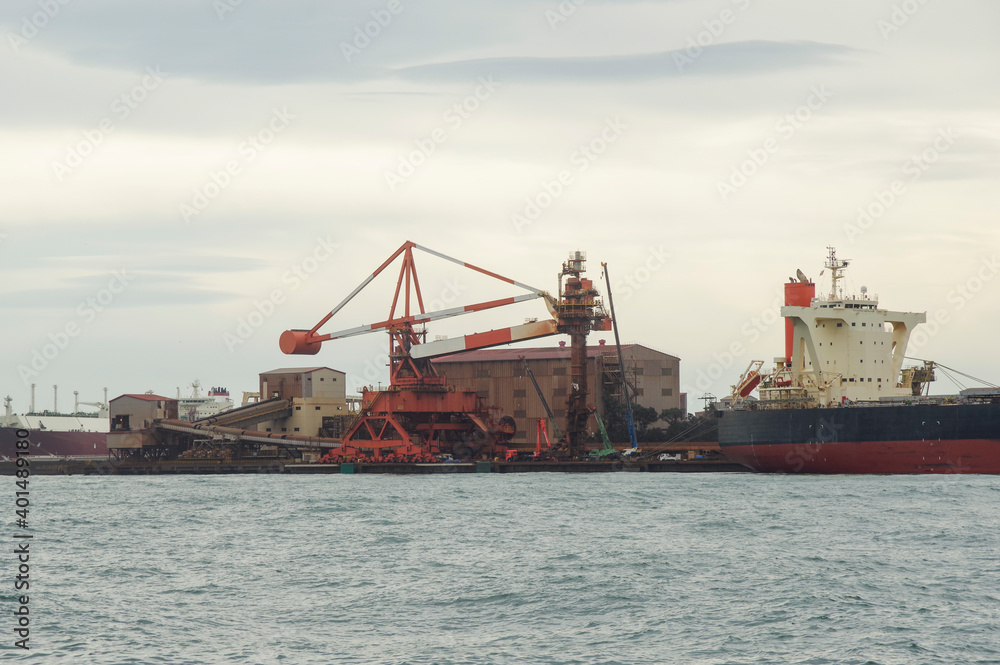 製鉄材料を積み降ろす埠頭に停泊する貨物船