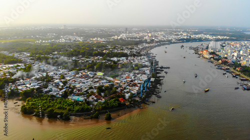Top view aerial view love bridge or Ninh Kieu quay of downtown in Can Tho City, Vietnam with development buildings, transportation, energy power infrastructure
