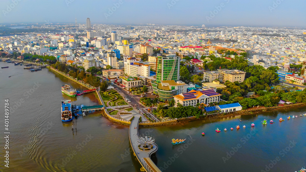 Top view aerial view love bridge or Ninh Kieu quay of downtown in Can Tho City, Vietnam with development buildings, transportation, energy power infrastructure