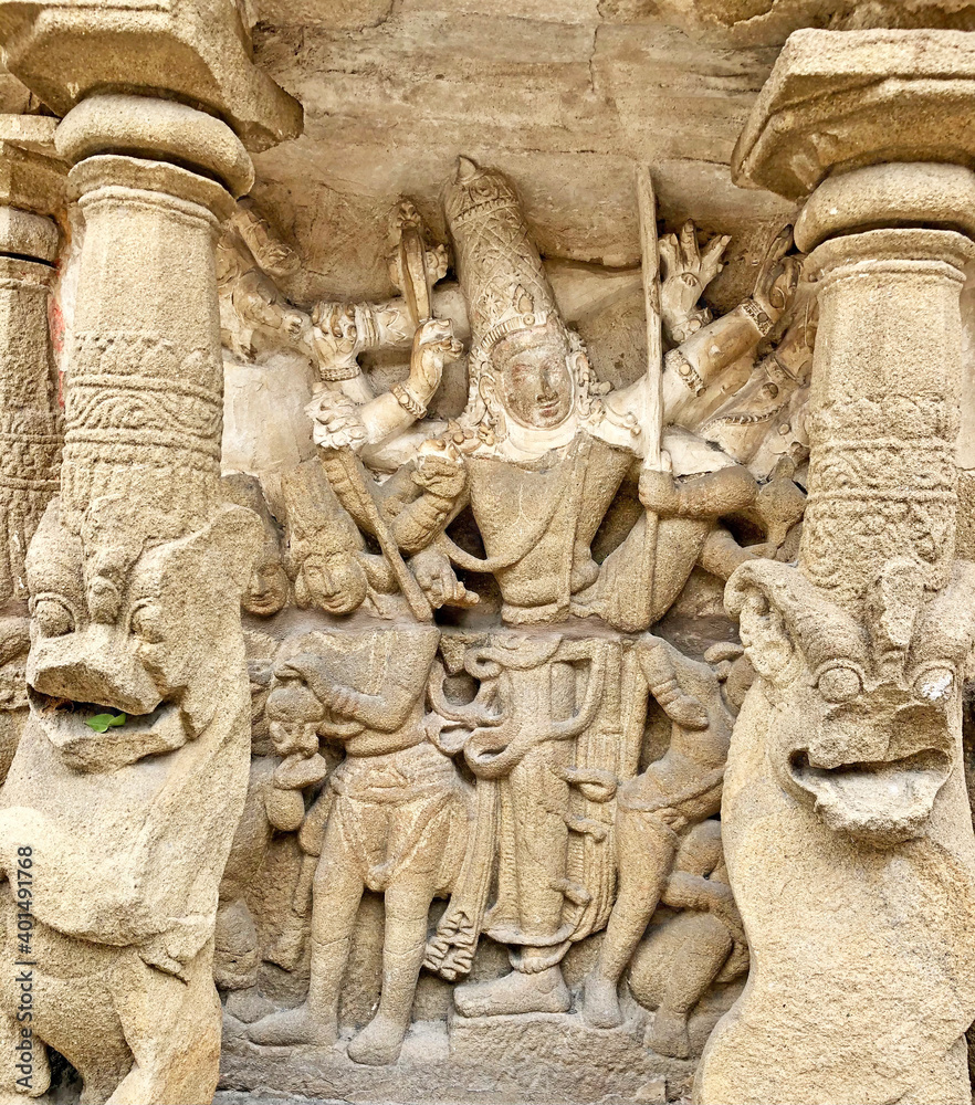 Hindu God deity statue. Ancient sandstone carved historical Hindu God