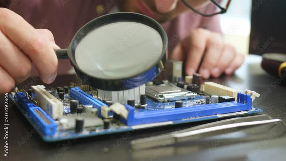 Technician repairing computer in service center, closeup Technician repairing computer in service center, closeup