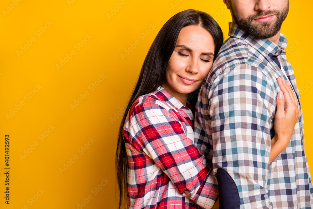 Photo portrait of woman hugging man from behind isolated on vivid yellow colored background with blank space