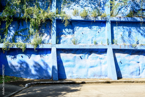 Heavy duty block retaining wall in bright blue color.  © Jim
