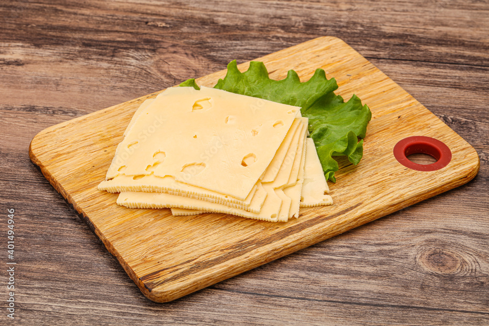 Sliced yellow cheese over board Sliced yellow cheese over board