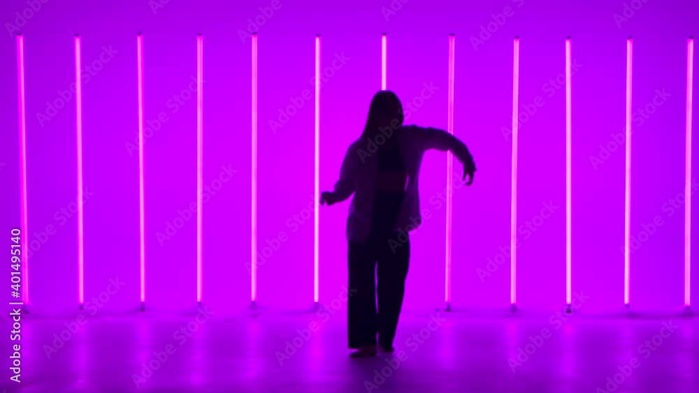Stylish young woman dancing hip hop, freestyle in the studio in slow motion. Youth lifestyle and emotion concept. Stylish young woman dancing hip hop, freestyle in the studio in slow motion. Youth lifestyle and emotion concept.