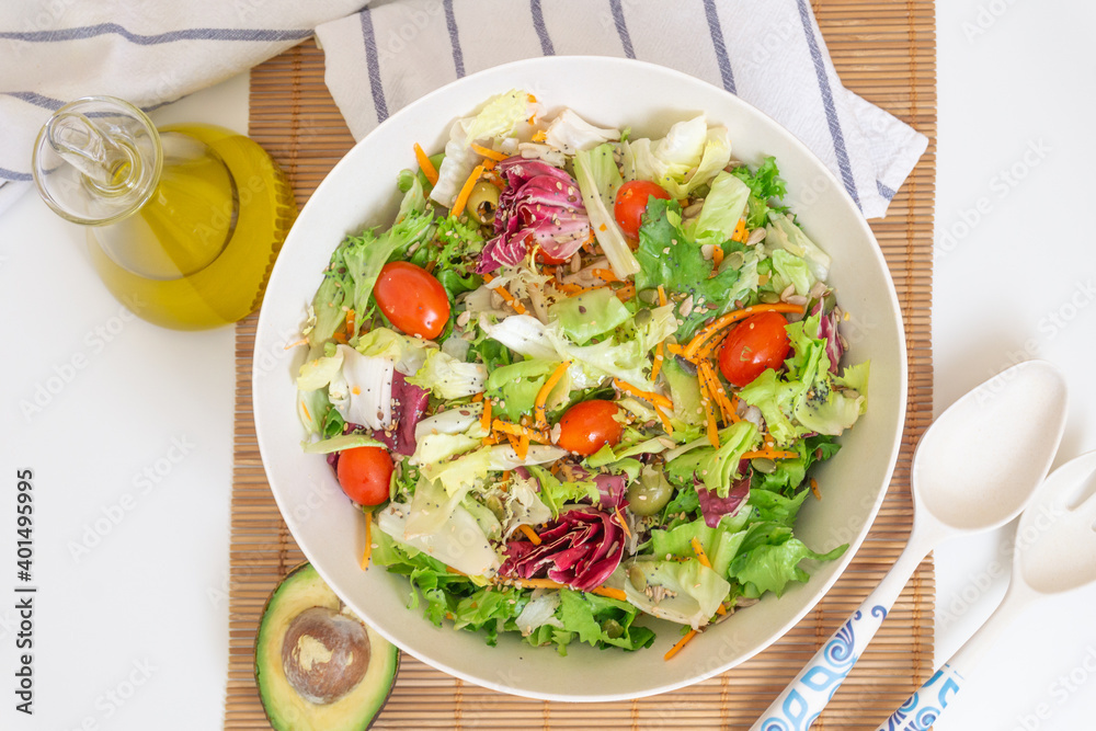 Top view of a salad with olive oil, avocado, vegetables and seeds Top view of a salad with olive oil, avocado, vegetables and seeds