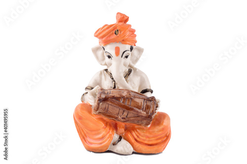 Indian god ganesha playing dholak isolated on white background with clipping path, lord Ganesha photo