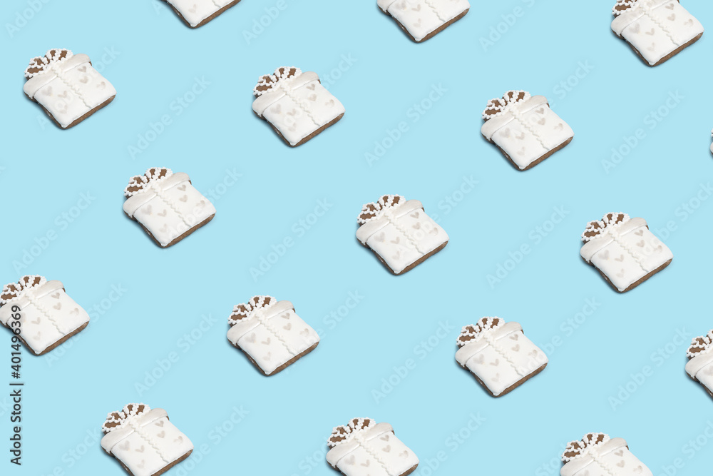 Creative minimal Christmas art. Pattern made with Christmas cookies on bright blue background. Flat lay. Copy space. Minimal composition.