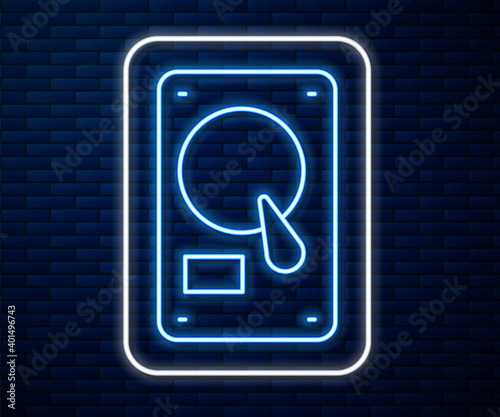Glowing neon line Hard disk drive HDD icon isolated on brick wall background. Vector Illustration.