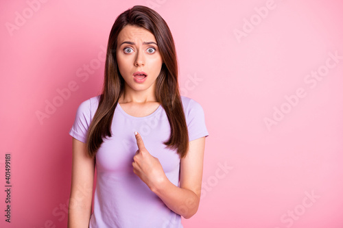 Photo portrait of shocked scared girl pointing finger at herself isolated on pastel pink colored background