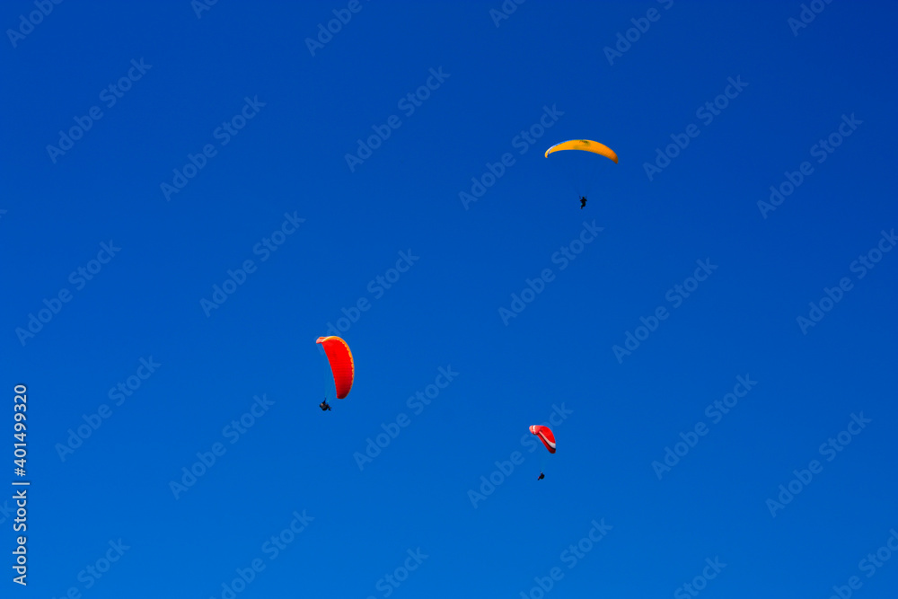 View of three Paraglider flying high over the lake lucerne in switzerland View of three Paraglider flying high over the lake lucerne in switzerland