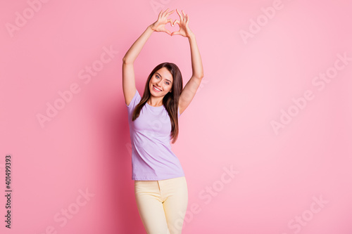 Photo portrait of lovely girlfriend demonstrating heart over head on saint valentines day isolated on pastel pink color background