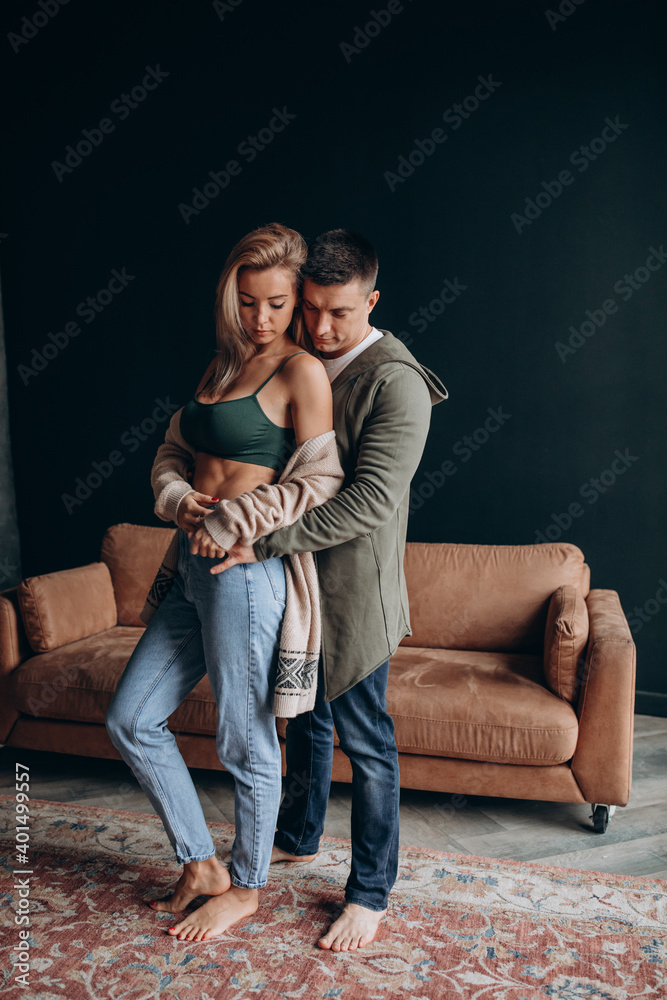 Photoshoot of a young couple in love. The solitude of a guy and a girl. Studio photography. Black background. Photoshoot of a young couple in love. The solitude of a guy and a girl. Studio photography. Black background.