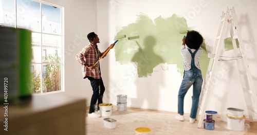 Εκτύπωση καμβά Back view of young lovely African American family married couple doing renovating works in house