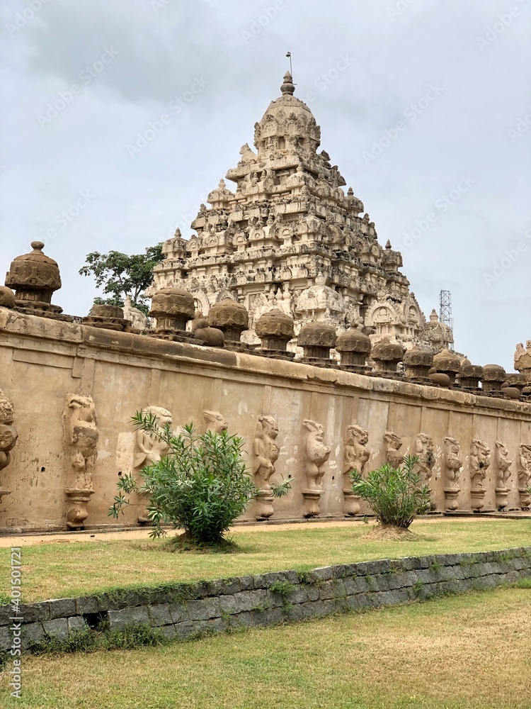 Temple tower against blue sky background. Ancient Hindu temple with sandstone carved historical Hindu God and animal sculptures.