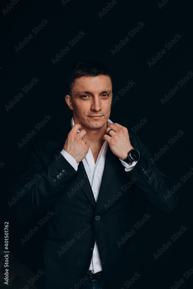 Portrait of a successful businessman. The guy in the black suit. Dark background. Portrait of a successful businessman. The guy in the black suit. Dark background.