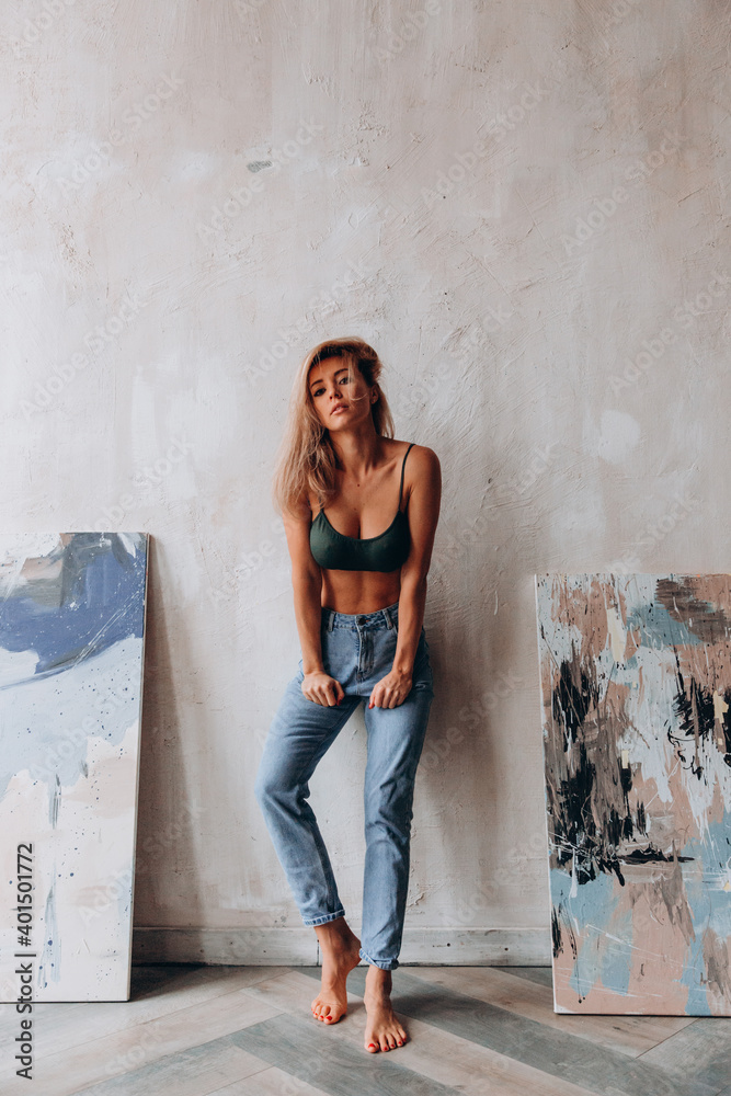 Photoshoot of a blonde in a black bra and jeans. Studio photography. Photos  | Adobe Stock