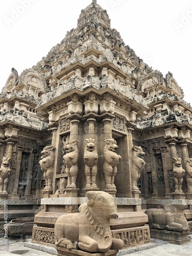 Temple tower against blue sky background. Ancient Hindu temple with sandstone carved historical Hindu God and animal sculptures. © Prabhakarans12