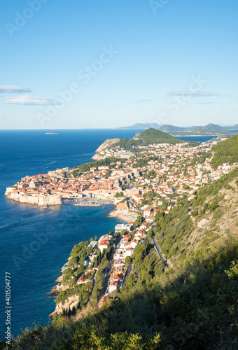 It is a landscape overlooking the walls of Dubrovnik, Croatia. The sky is blue and the blue of the Adriatic Sea is also shining. © Tom Spark