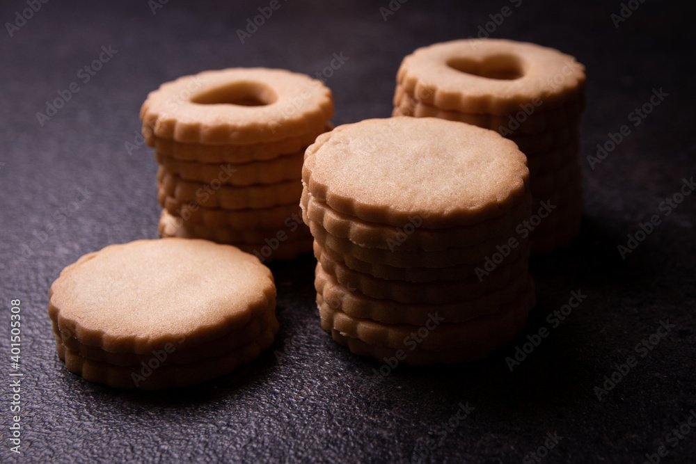 Homemade traditional Christmas shortbread biscuits cookies with red jam on plate.