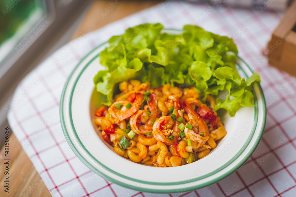 Macaroni, shrimps, Tomato and vegetable Served in White Plates on Table