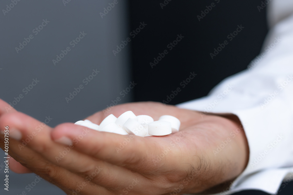 Close-up of man holding medicines. Close-up of man holding medicines.