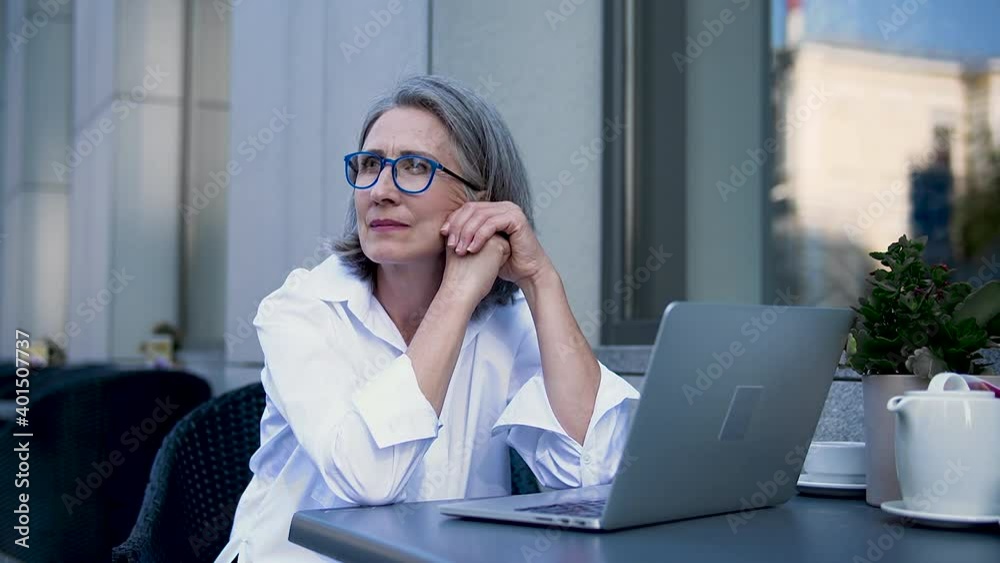 Pensive woman writer contemplating about plot of new book sitting outdoor café Pensive woman writer contemplating about plot of new book sitting outdoor café
