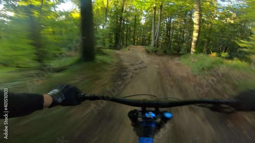 Speed downhill mountain bike riding in a forest. View from first person perspective POV.