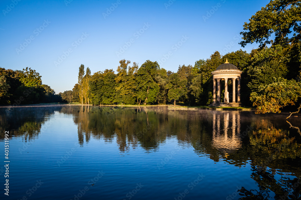 Pavillion reflection at sunrise in a park in Munich, Bavaria, Germany