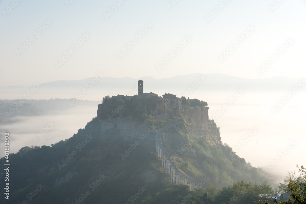 It is a village of Civita di Bagnoregio in Lazio, Italy. Surrounded by the sea of clouds in the morning, it is a fantastic landscape.