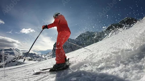 Pretty woman skiing. Young girl rides along the freshly groomed slope. 
Young girl spending an active vacation in the Austrian Alps. Stabilized footage. Slow motion. 
