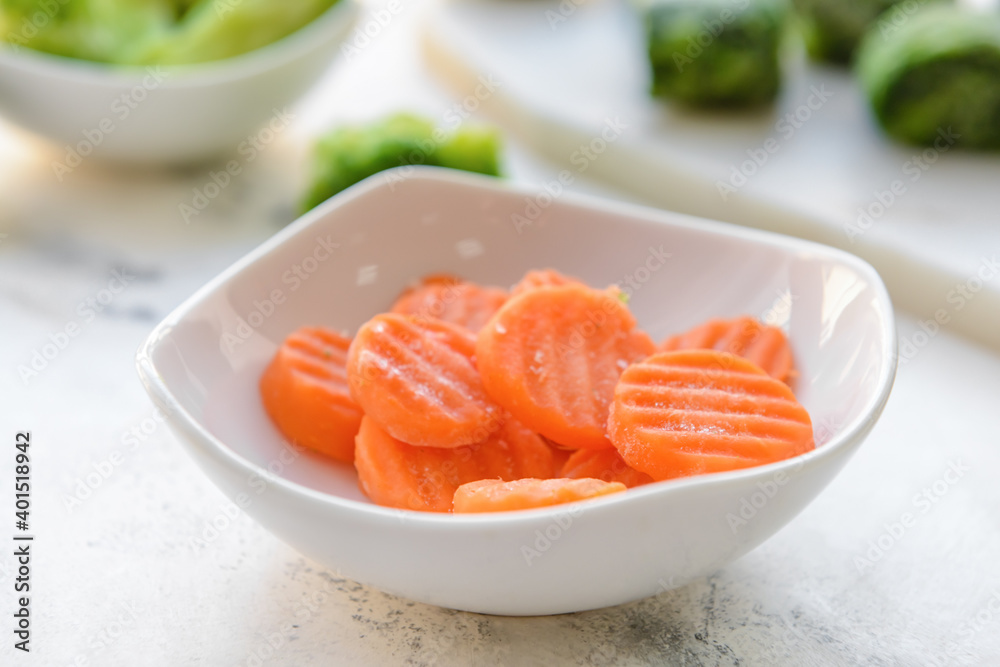 Frozen vegetables in bowl on light background Frozen vegetables in bowl on light background