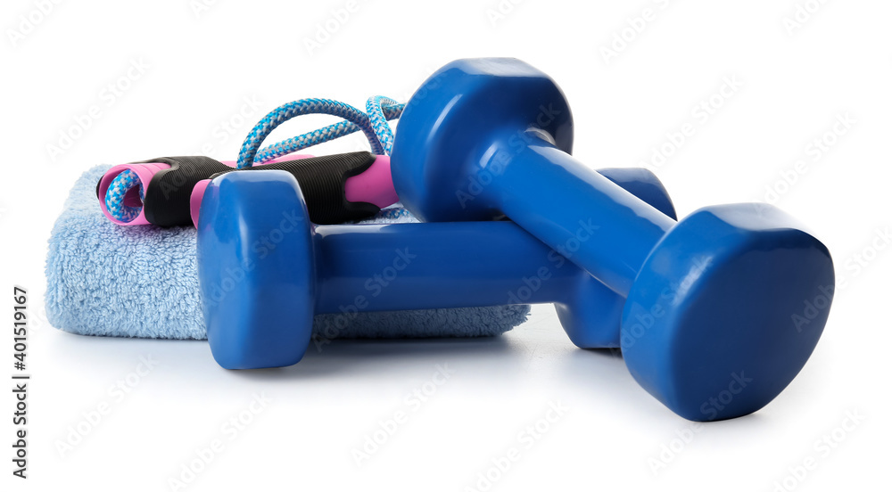 Dumbbells, towel and jumping rope on white background Dumbbells, towel and jumping rope on white background