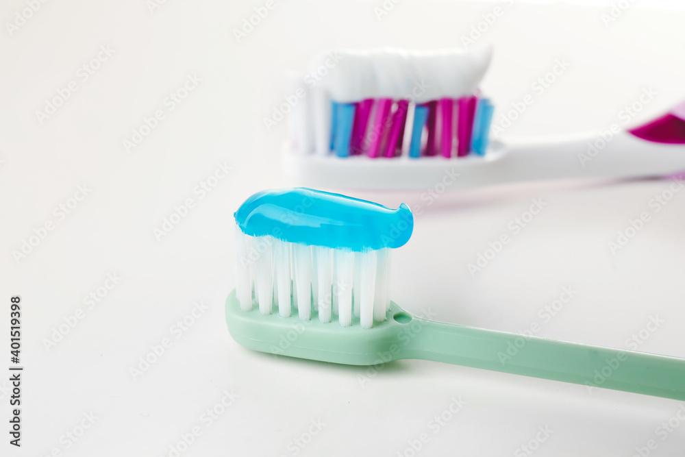 Toothbrushes with paste on white background Toothbrushes with paste on white background