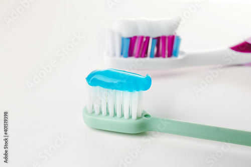 Toothbrushes with paste on white background © Pixel-Shot