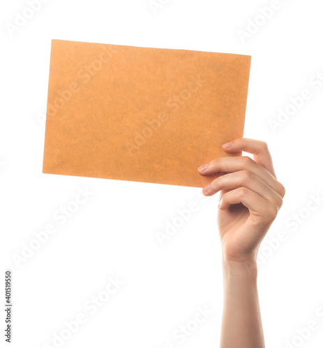 Female hand with blank paper sheet on white background © Pixel-Shot