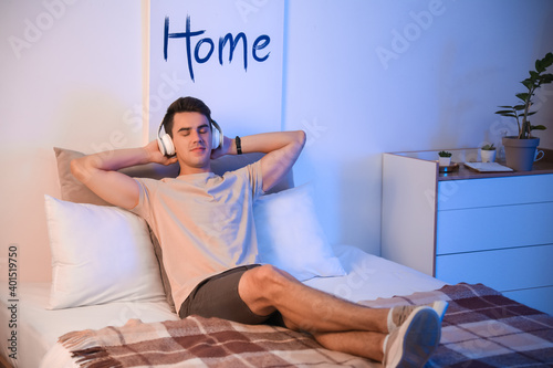 Young man listening to musi...