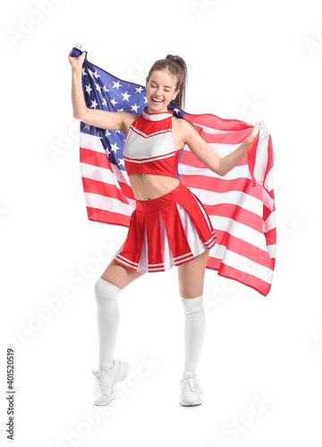 Beautiful young cheerleader with USA flag on white background