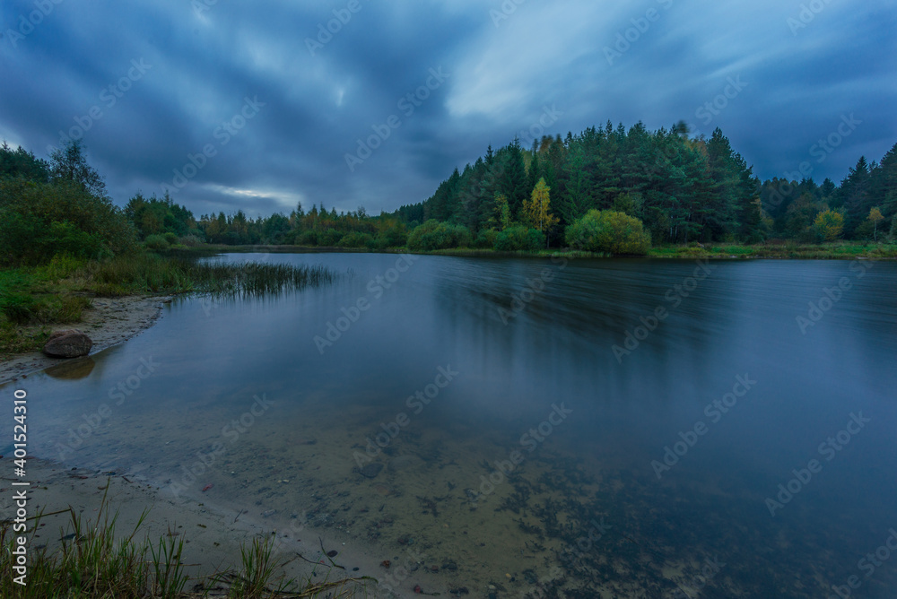 Small forest lake on a cloudy night, inBelarus