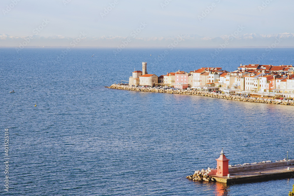 Piran, Picturesque seaside old  town in Slovenia against snow covered alps mountains in winter.