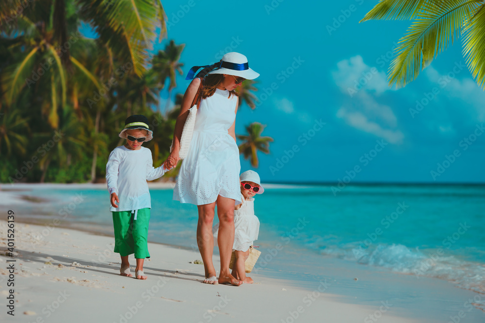 mother with kids on tropical beach vacation