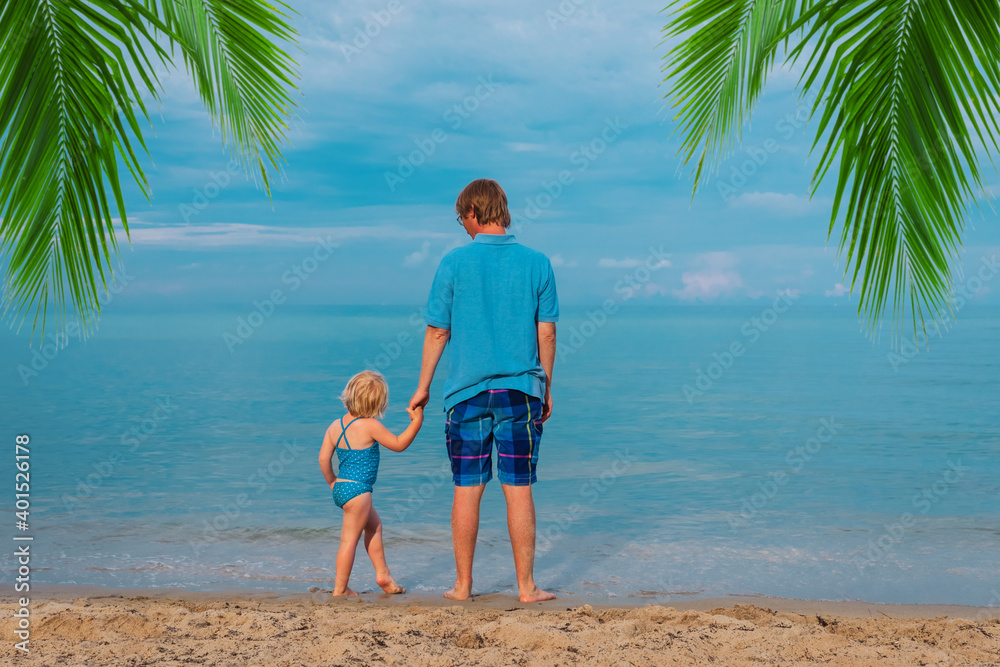 father with little baby daughter walk on tropical beach father with little baby daughter walk on tropical beach