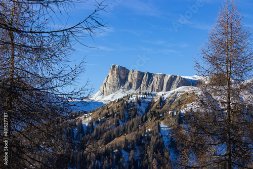 Italian mountains winter landscape. The first snow fallen in the Dolomite. View of Mount Lastoni di Formin sprinkled with fresh snow and surrounded by trees. photo