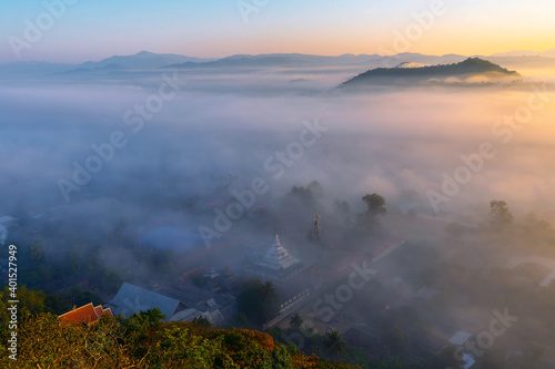 The sea of ​​mist in the winter morning covers the village below in Li District, Lamphun Province, Thailand.