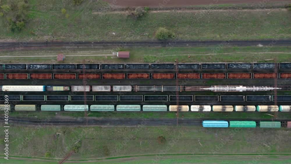 An aerial drone view of a diesel locomotive pulling railway carriages. An aerial drone view of a diesel locomotive pulling railway carriages.